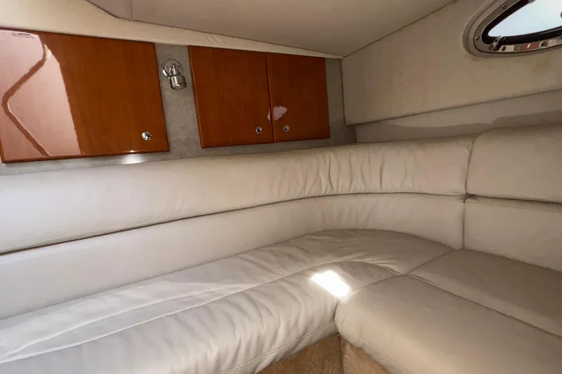 Slide: The Image of Interior of 2005 Formula 31 Performance Cruiser with white leather seating and wooden cabinets. - 60