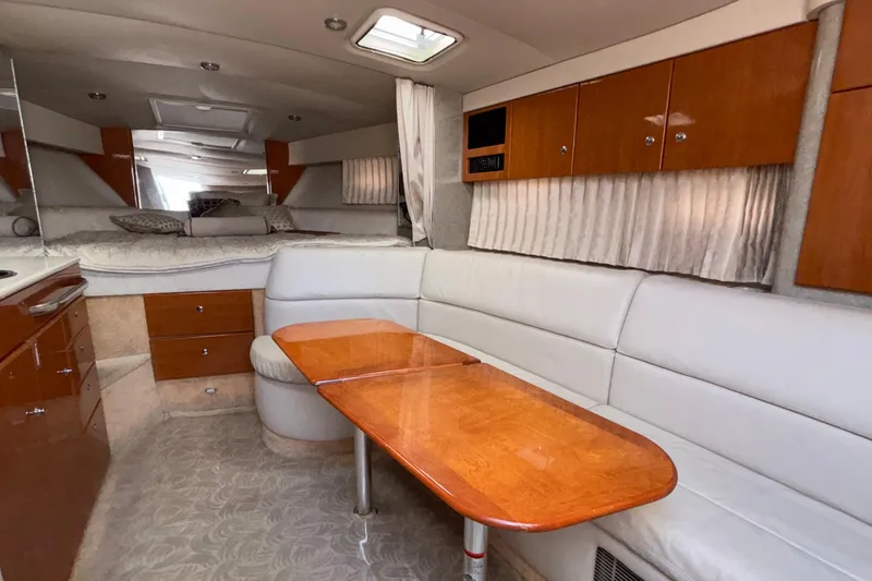 Slide: The Image of 2005 Formula 31 Performance Cruiser interior with white seating and wooden table. - 62