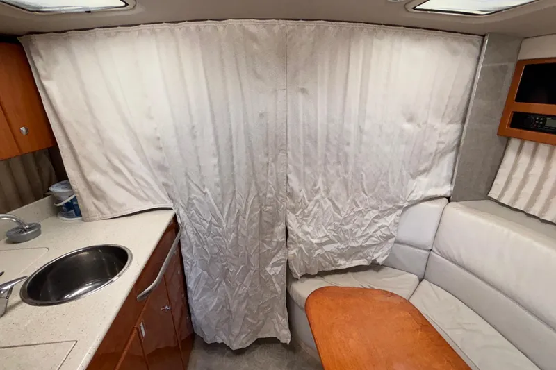 Slide: The Image of 2005 Formula 31 Performance Cruiser interior with kitchenette, sink, and seating area. - 67