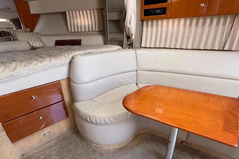 Slide: The Image of Interior of a 2005 Formula 31 Performance Cruiser with seating and wooden table. - 68