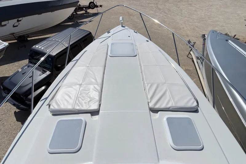 Slide: The Image of 2005 Formula 31 Performance Cruiser deck with sun pads, parked near vehicles. - 70