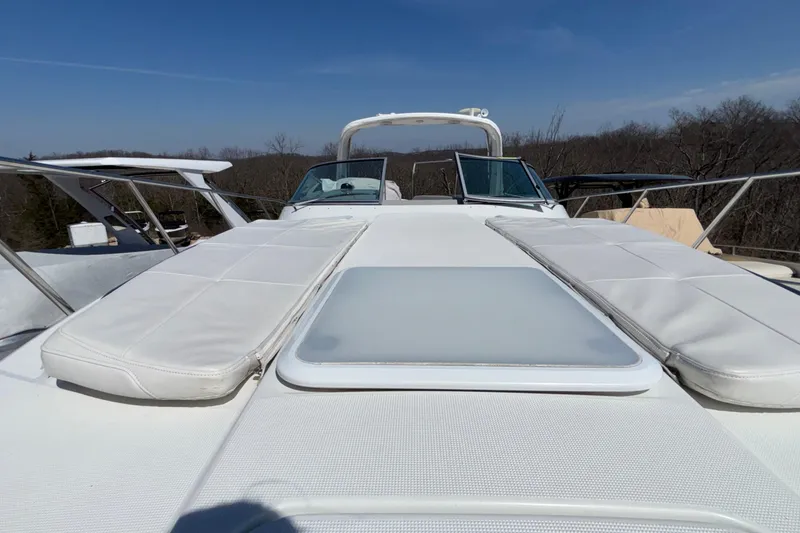 Slide: The Image of 2005 Formula 31 Performance Cruiser with sunpads on deck, under clear blue sky. - 71