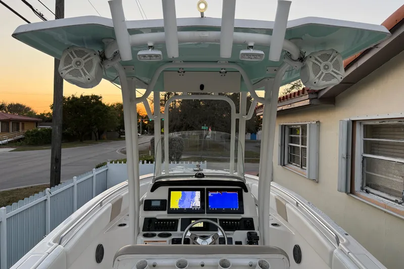 Slide: The Image of 2018 Robalo R242 Center Console boat with advanced navigation system at sunset. - 26
