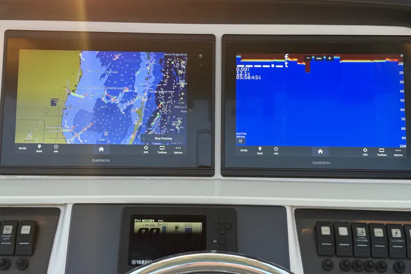 Slide: The Image of Garmin navigation displays on 2018 Robalo R242 Center Console boat dashboard. - 27
