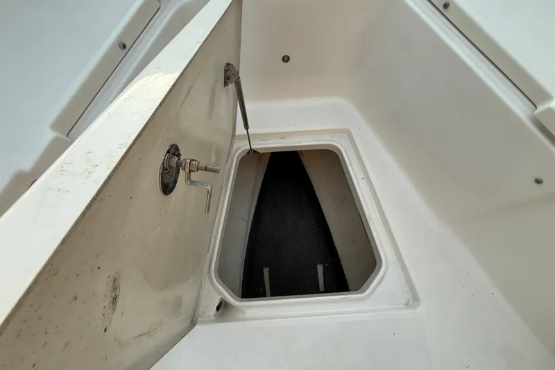 Slide: The Image of Open storage compartment on 2018 Robalo R242 Center Console boat. - 35
