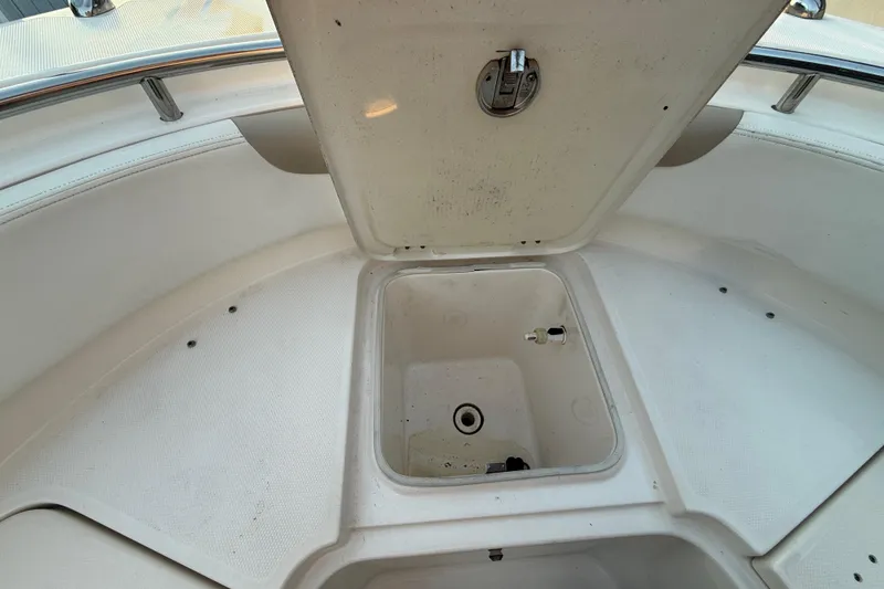 Slide: The Image of Open storage compartment on 2018 Robalo R242 Center Console boat. - 36