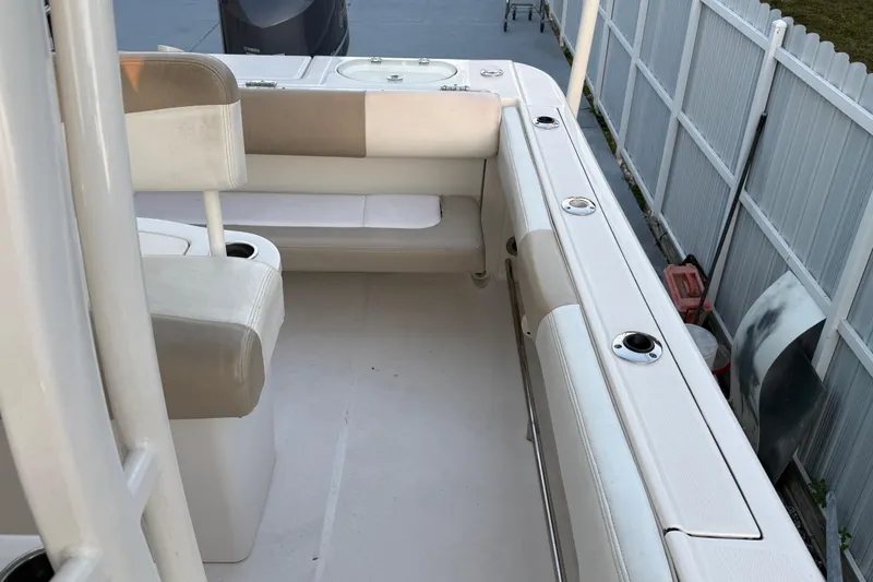 Slide: The Image of 2018 Robalo R242 Center Console boat interior with seating and rod holders. - 37
