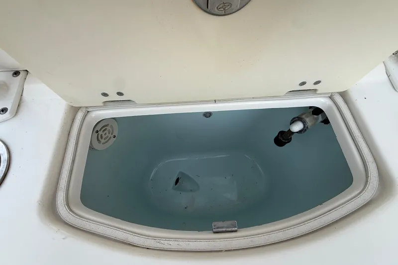 Slide: The Image of 2018 Robalo R242 Center Console livewell with open lid and water inside. - 42