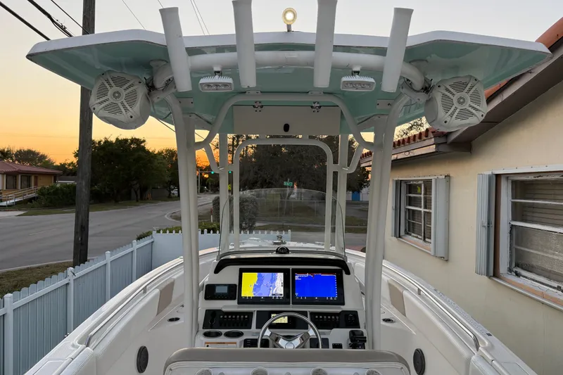 Slide: The Image of 2018 Robalo R242 Center Console boat with advanced navigation system at sunset. - 47
