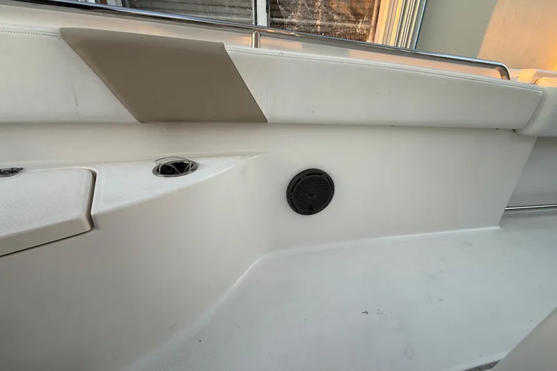 Slide: The Image of 2018 Robalo R242 Center Console interior with speaker and cushioned seating. - 50