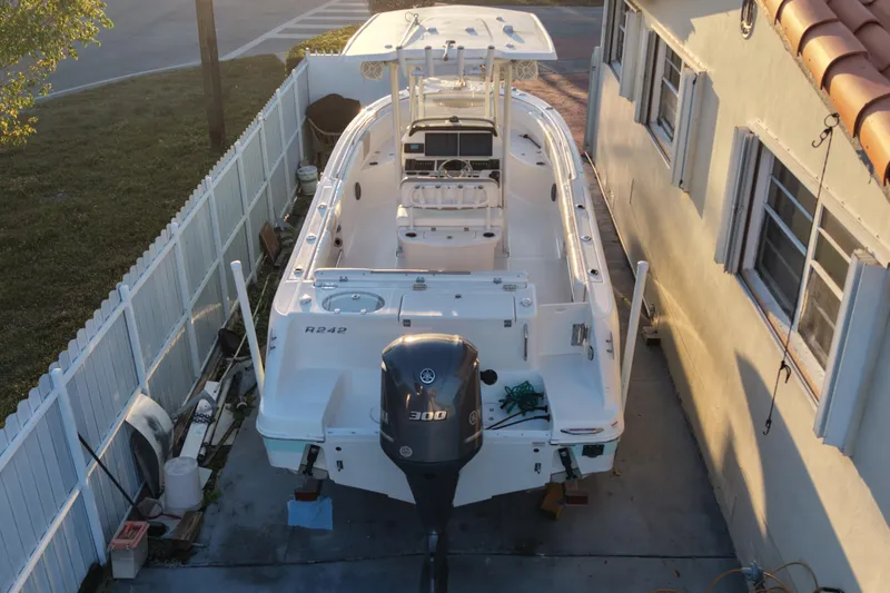 Slide: The Image of 2018 Robalo R242 Center Console boat parked in a driveway, viewed from above. - 7