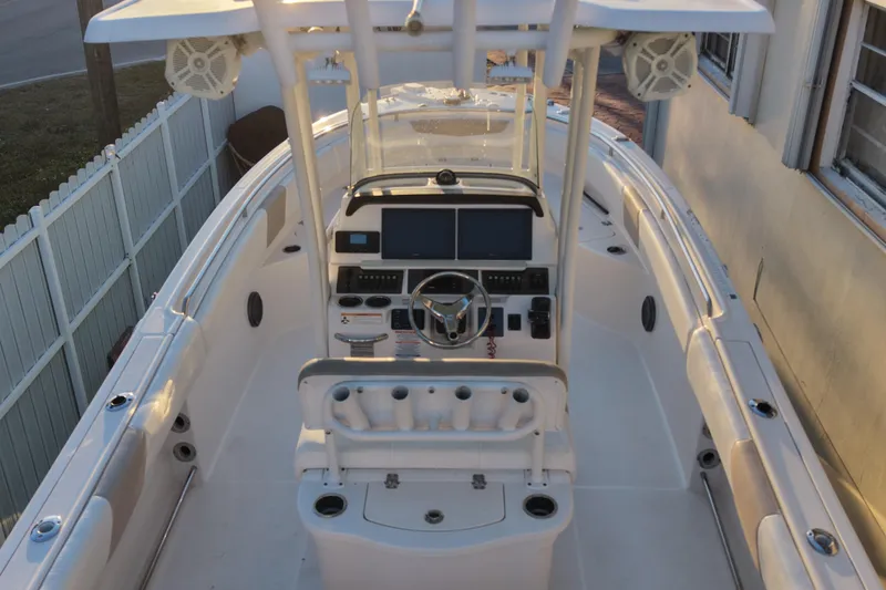 Slide: The Image of 2018 Robalo R242 Center Console boat interior with steering wheel and control panel. - 9