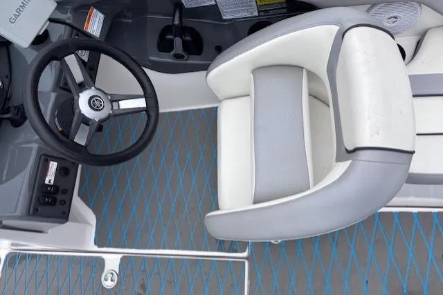 Slide: The Image of 2017 Yamaha Boats SX190 cockpit with steering wheel and cushioned seat. - 10