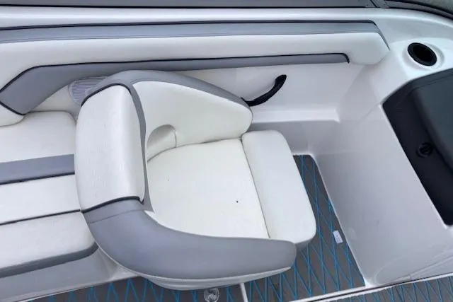 Slide: The Image of 2017 Yamaha Boats SX190 interior seating with white and gray upholstery. - 12