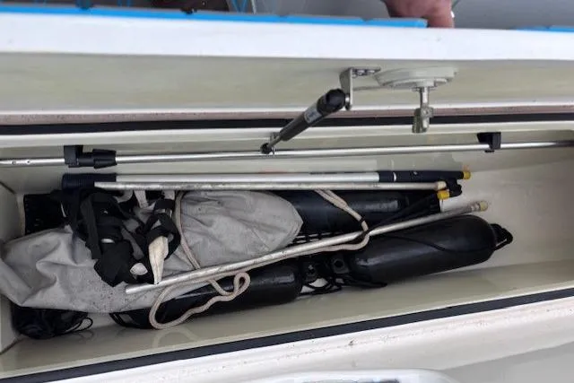 Slide: The Image of Storage compartment of a 2017 Yamaha Boats SX190, containing boating equipment and accessories. - 13