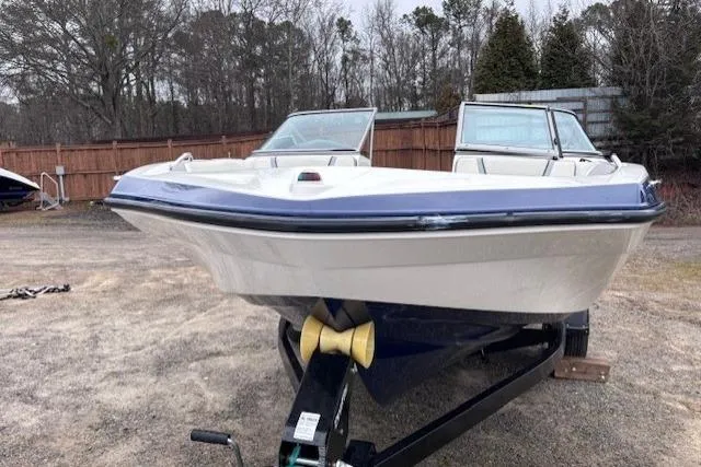 Slide: The Image of 2017 Yamaha Boats SX190 on trailer, parked outdoors with trees in background. - 2