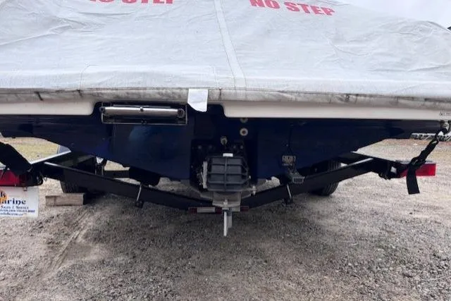 Slide: The Image of 2017 Yamaha Boats SX190 covered on trailer, rear view, parked on gravel. - 6