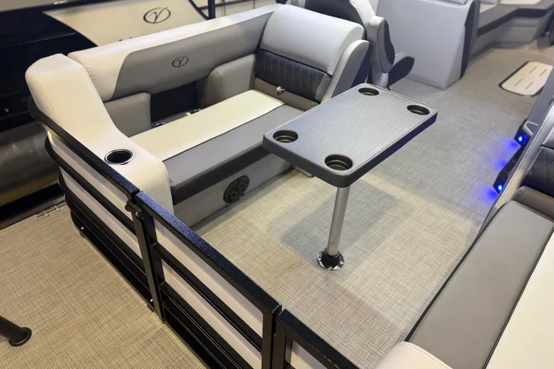 Slide: The Image of 2026 Veranda VS 22 RC boat interior with cushioned seating and table, featuring cup holders. - 2