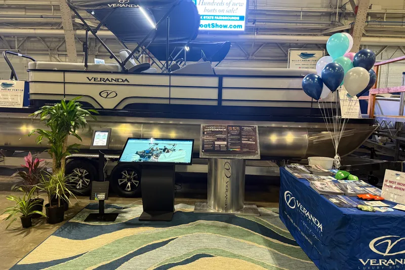 Slide: The Image of 2026 Veranda VS 22 RC luxury pontoon boat displayed at a boat show with promotional materials. - 9