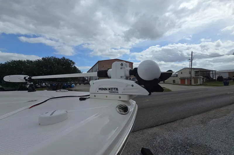 Slide: The Image of 2021 Robalo 246 Cayman with Minn Kota Terrova trolling motor on a cloudy day. - 13