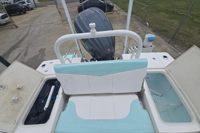 Slide: The Image of 2021 Robalo 246 Cayman boat interior with storage compartments and outboard motor. - 16