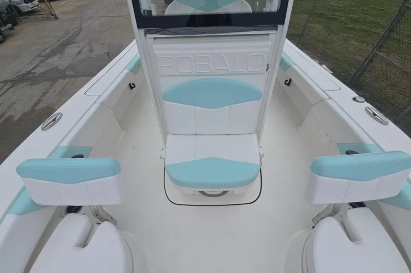 Slide: The Image of 2021 Robalo 246 Cayman boat interior with light blue and white seating. - 20