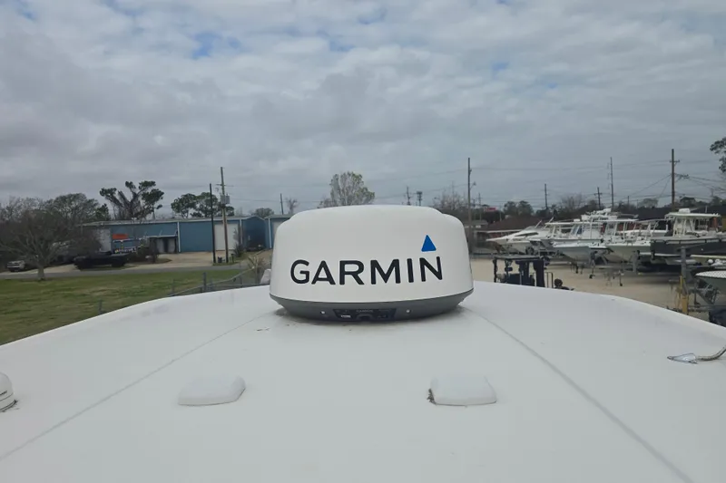 Slide: The Image of 2021 Robalo 246 Cayman boat with Garmin radar, docked in a marina. - 28