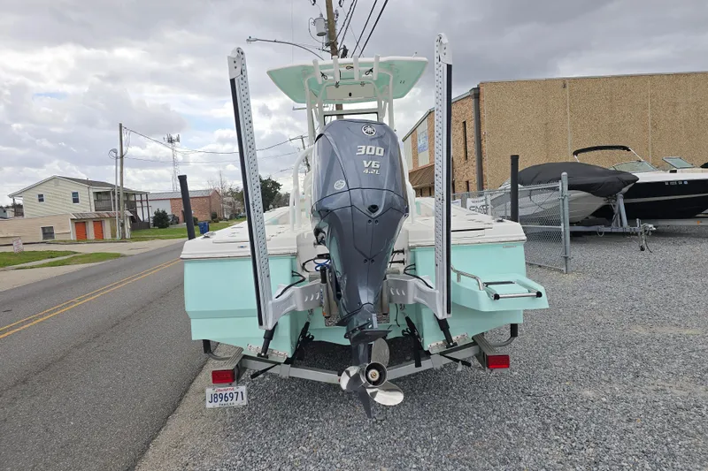 Slide: The Image of 2021 Robalo 246 Cayman boat with Yamaha 300 V6 engine, parked on a street. - 3