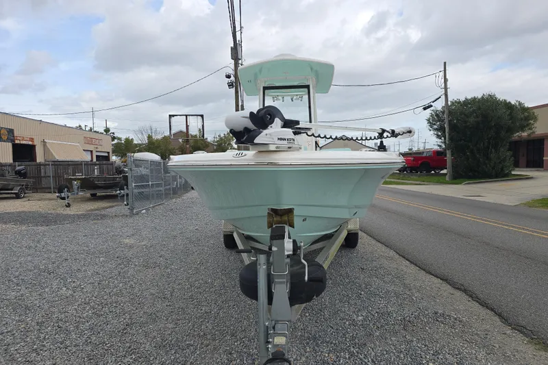 Slide: The Image of 2021 Robalo 246 Cayman boat on trailer, parked on gravel lot, overcast sky. - 4
