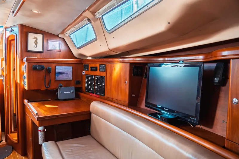 Slide: The Image of Interior of 2003 Hunter 356 sailboat with navigation station and seating area. - 11