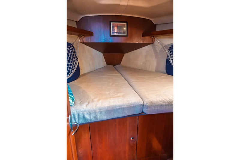 Slide: The Image of Interior cabin of 2003 Hunter 356 sailboat with cozy V-berth and wooden cabinetry. - 14