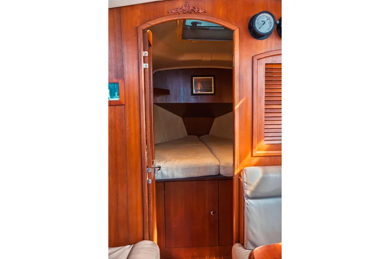 Slide: The Image of Cozy cabin interior of 2003 Hunter 356 sailboat with wooden finish and comfortable bedding. - 15
