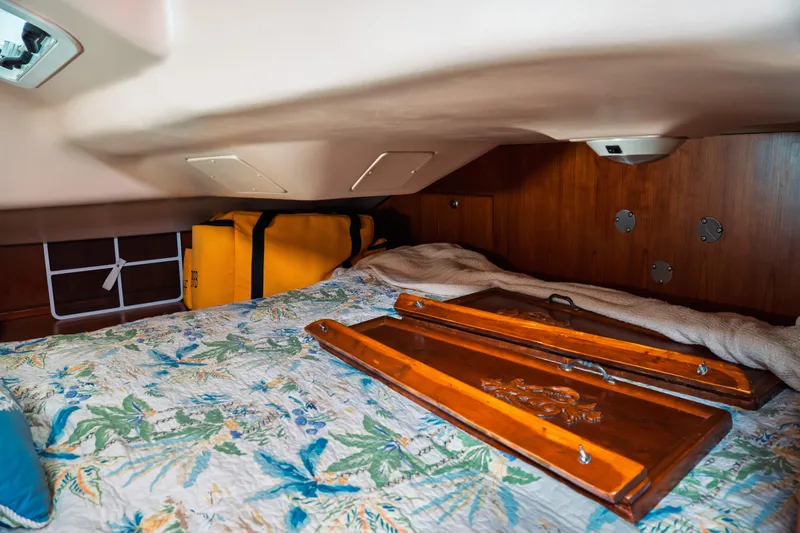 Slide: The Image of Cozy cabin interior of 2003 Hunter 356 sailboat with floral bedding and wooden accents. - 17