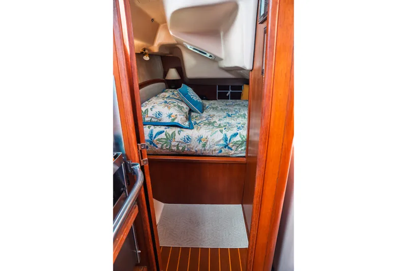 Slide: The Image of Cozy cabin interior of 2003 Hunter 356 sailboat with floral bedding and wooden finish. - 19