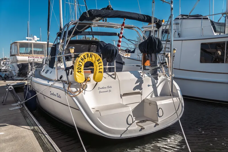 Slide: The Image of 2003 Hunter 356 sailboat "Southern Belle" docked at marina, sunny day. - 2