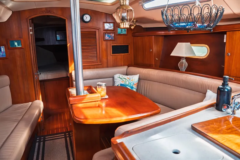 Slide: The Image of Luxurious interior of a 2003 Hunter 356 sailboat with wooden furnishings and cozy seating. - 20