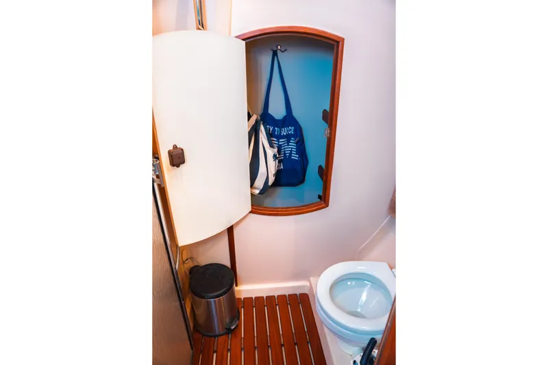 Slide: The Image of Compact bathroom in 2003 Hunter 356 sailboat with toilet and storage. - 23