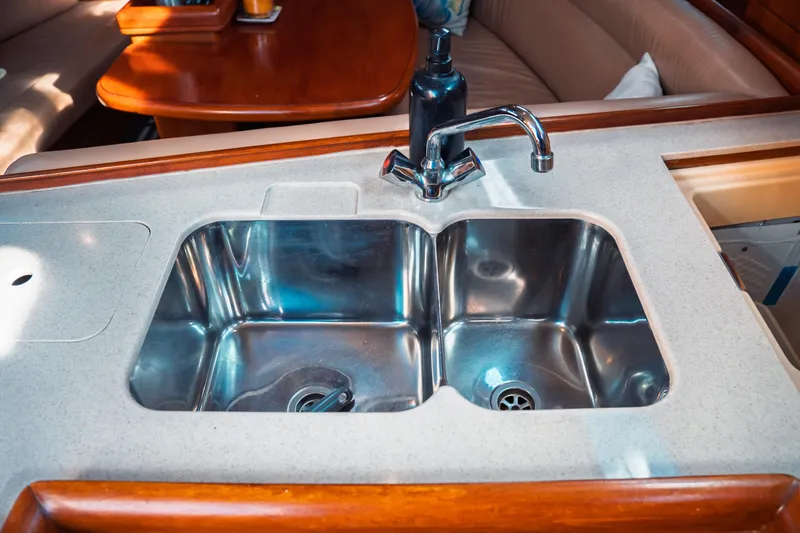 Slide: The Image of Stainless steel sink in 2003 Hunter 356 yacht kitchen with wooden accents. - 29
