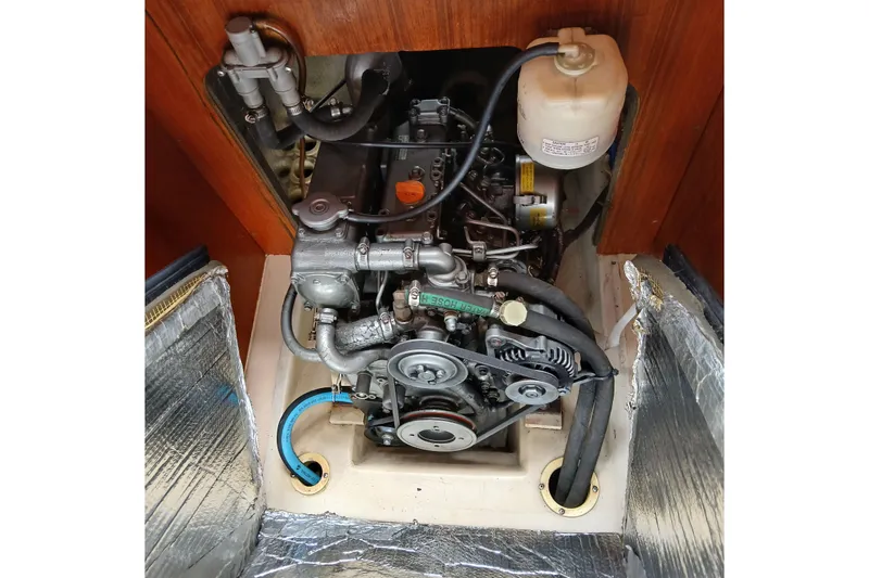 Slide: The Image of Engine compartment of a 2003 Hunter 356 sailboat, showcasing mechanical components. - 39