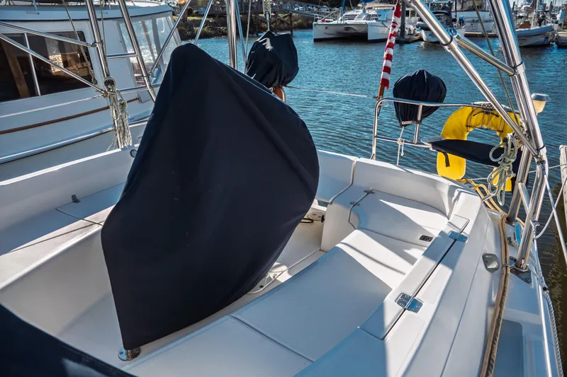 Slide: The Image of 2003 Hunter 356 sailboat cockpit with covered wheel, docked in marina. - 4