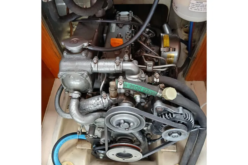 Slide: The Image of Engine of a 2003 Hunter 356 sailboat, showcasing mechanical components and hoses. - 40