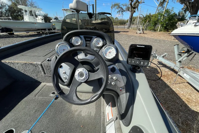 Slide: The Image of 2015 Tracker Pro Team 190 TX boat dashboard with steering wheel and gauges. - 6