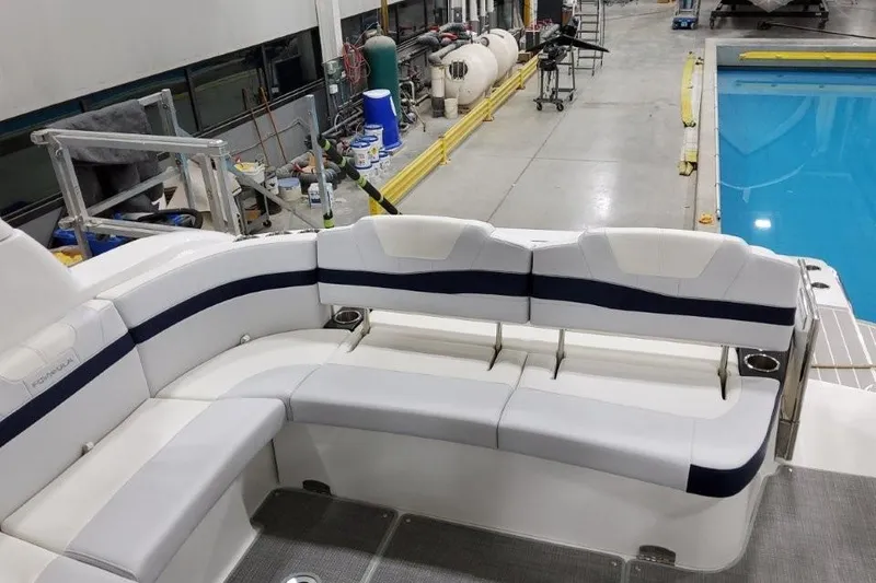 Slide: The Image of 2022 Formula 37 Performance Cruiser interior with white seating near a pool in a workshop. - 11