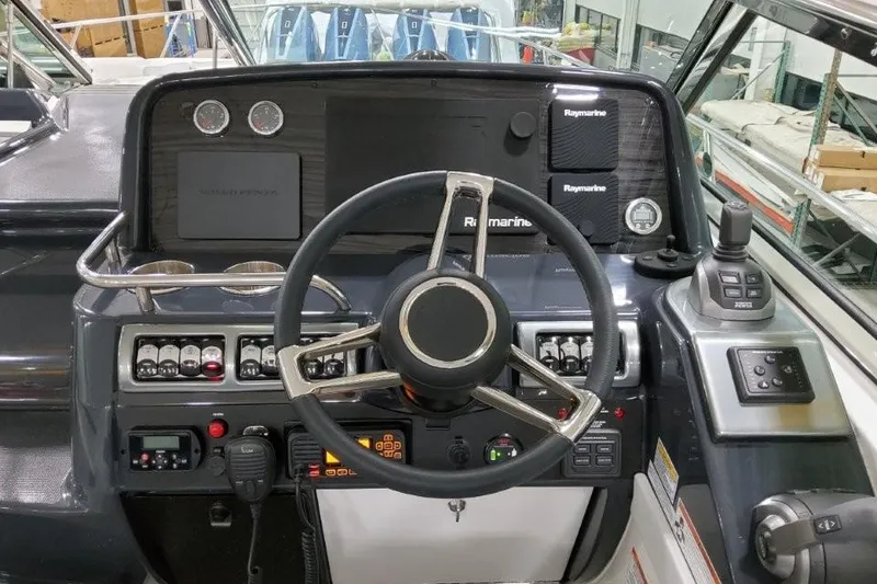 Slide: The Image of 2022 Formula 37 Performance Cruiser helm with advanced navigation controls and steering wheel. - 17
