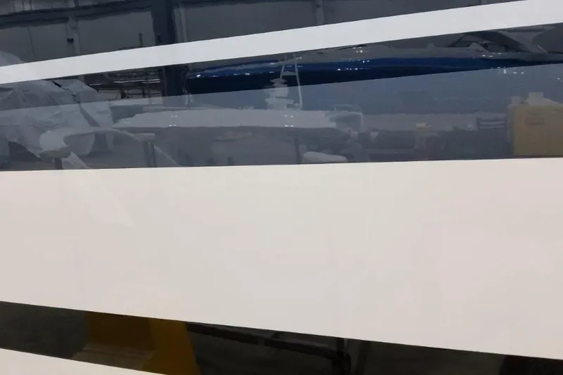 Slide: The Image of 2022 Formula 37 Performance Cruiser with sleek, reflective hull design in a workshop setting. - 22