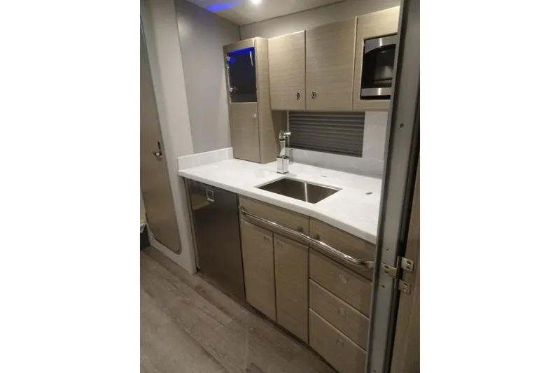 Slide: The Image of Modern kitchen in 2022 Formula 37 Performance Cruiser with sleek cabinetry and stainless steel appliances. - 25