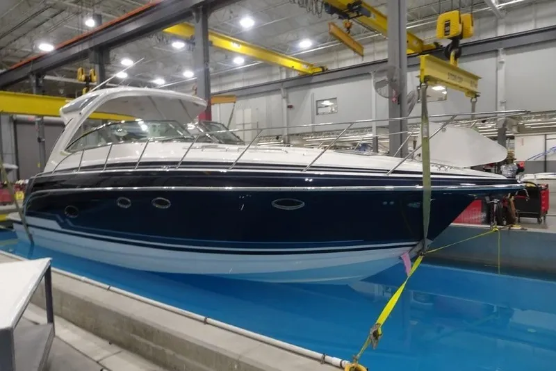 Slide: The Image of 2022 Formula 37 Performance Cruiser in a factory setting, suspended above water. - 3