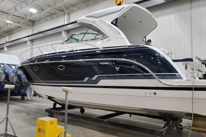 Slide: The Image of 2022 Formula 37 Performance Cruiser in a warehouse, showcasing sleek design and modern features. - 5