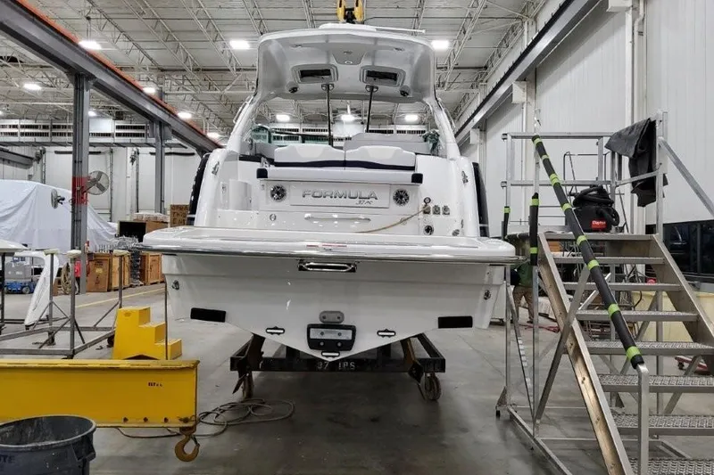 Slide: The Image of 2022 Formula 37 Performance Cruiser in a workshop, rear view, under maintenance. - 9