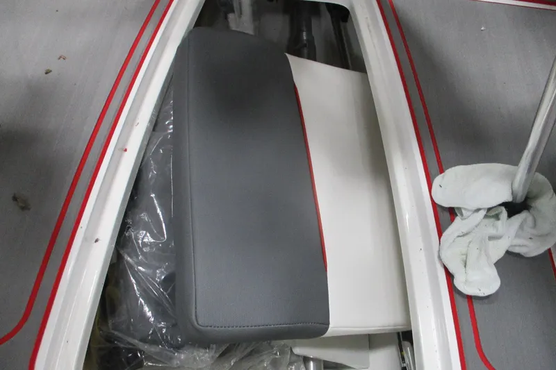 Slide: The Image of 2024 Tahoe 210 S Limited boat interior with gray and white seating, red accents. - 7